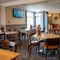The interior restaurant and seating area with TV at The Woodlands.