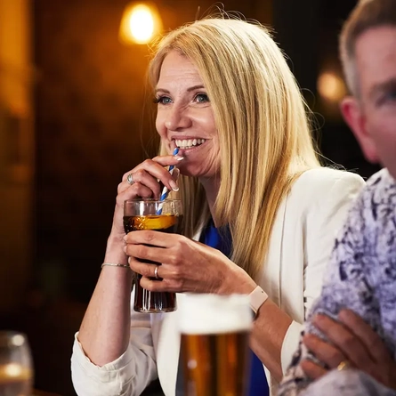 A woman drinking cola in the pub