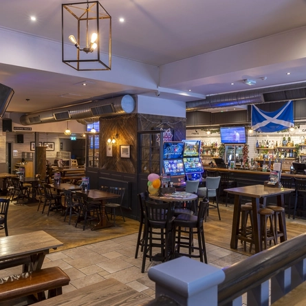 Interior dining area of a pub with a bar.