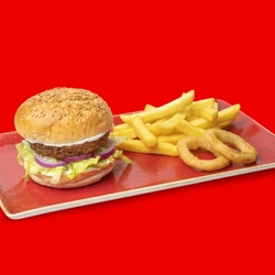The Hungry Horse Classic Impossible Burger served on a red plate with fries and onion rings, on a bright red background. 