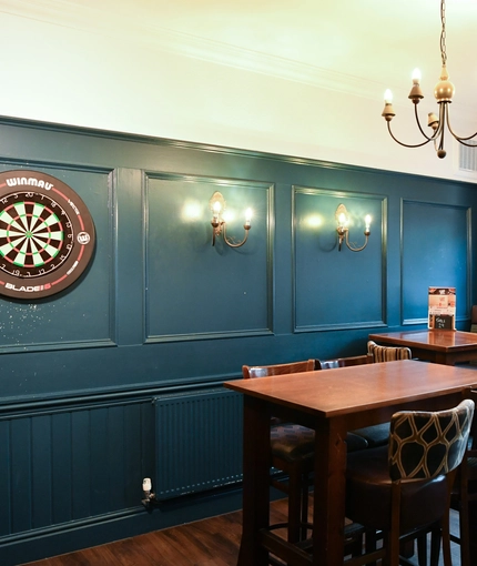 interior dining area of a pub with a dartboard