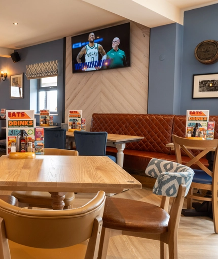 The interior restaurant and seating area with TV at the Gatehouse.