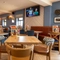 The interior restaurant and seating area with TV at the Gatehouse.