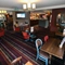 Interior dining area of a pub with a TV.