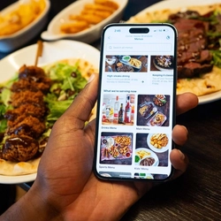 Someone ordering from the Greene King app at Flaming Grill.