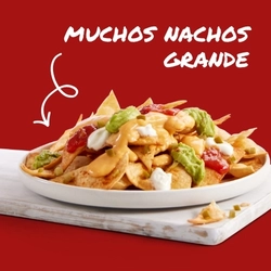 A banner promoting the Muchos Nachos Grande meal at Hungry Horse venues. The banner shows nachos topped with sauces served on a plate which sits on a wooden serving board.