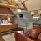 interior room of a hotel with a double bed, a sofa, a desk and a TV