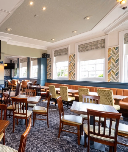 The interior restaurant and seating area with TV at the Black Horse.