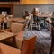 The interior restaurant seating area at The Tamar in Crownhill, with an upholstered booth seat, a fireplace, and a TV on the wall above it.