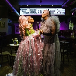 An image of Tequila Thirst and Anna Toni within the interior restaurant seating area and live event stage in the background at The City Of Quebec.