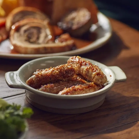 A dish of honey mustard chipolatas.