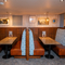 An interior restaurant seating area at The Wrekin Giant, with upholstered booth seats, and framed artwork on the wall.