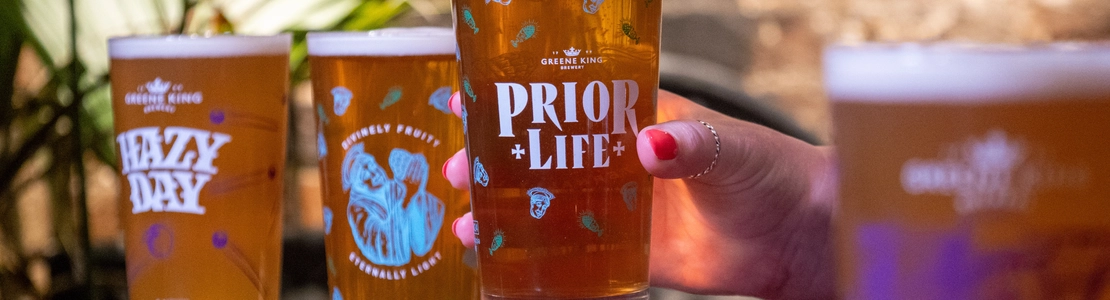 Glasses of Prior Life and Hazy Day beers, on a table.