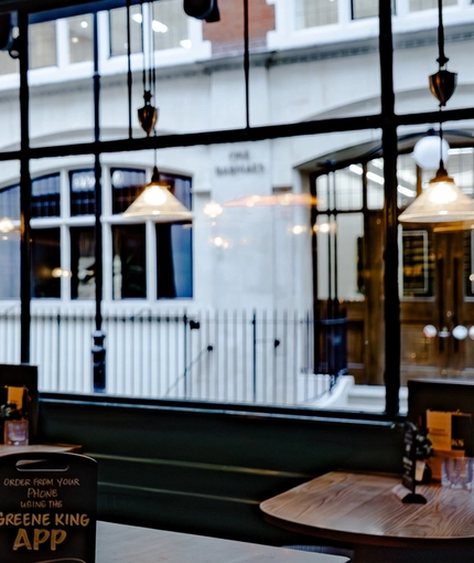 The interior restaurant seating area with advertising chalkboard signage at The Three Crowns.