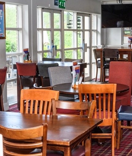 Interior dining area of a pub with a TV.