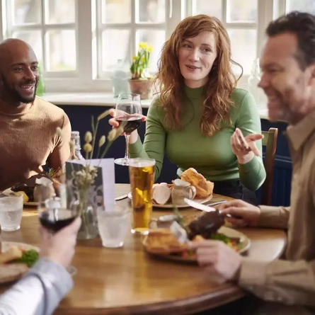 A group of people having a meal at a table.