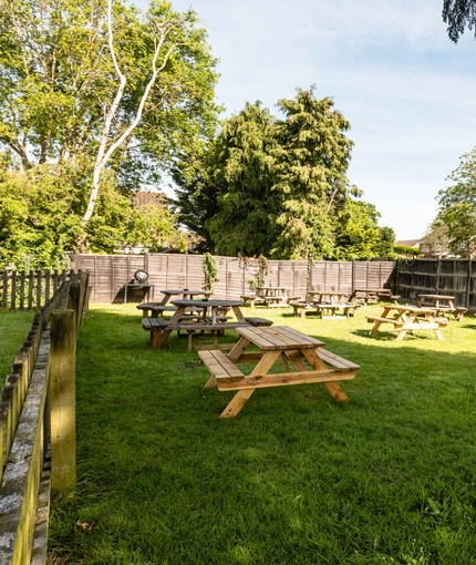 Exterior beer garden of a pub with a seating area.