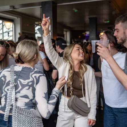 An image focusing on a group of friends enjoying the entertainment during The Boat Race event at The Crabtree.