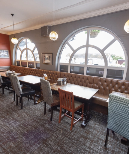 Interior dining area of a pub with a TV.