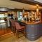 The bar area of The Old Bell with some stools around it.