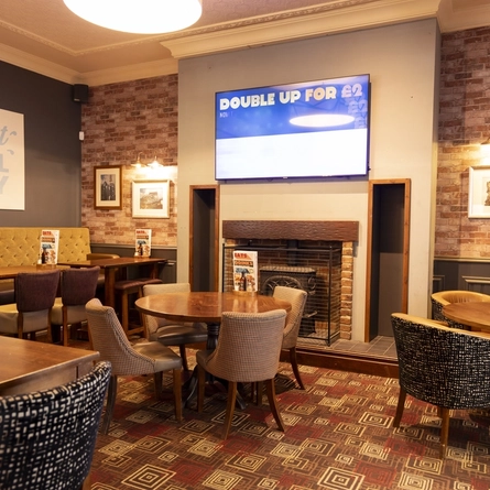 The interior restaurant and seating area with TV at the Kingstown.