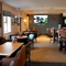 The interior restaurant seating area at The Steam Turbine in Rugby, with a TV on the wall, and a dartboard.