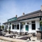 Exterior facade of a pub with a seating area.