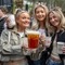 An image of 3 friends stood within the beer garden area with drinks during The Boat Race event at The Crabtree.