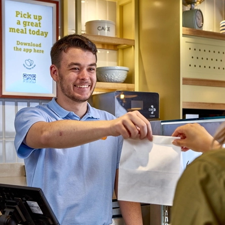 Server handing over a takeaway