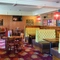 Interior dining area of a pub with a TV.