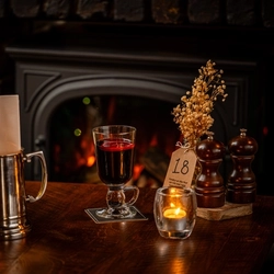 A glass of mulled wine served by the fire at The Three tuns.