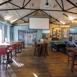 The interior restaurant seating area with TV and projector screen plus pool table at The Post Office Bar.