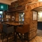 Interior dining area of a pub with a TV.