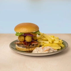 A Camembert Burger served on a plate with fries and coleslaw.