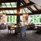 Interior conservatory of a pub with a dining area.