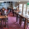 Interior dining area of a pub with a few TVs.