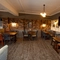 Interior dining area of a pub with a TV.