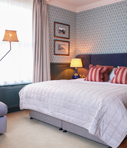 Double bed in hotel room with a sofa bed 