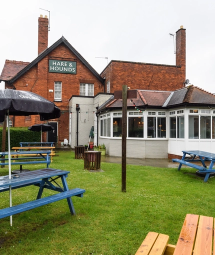 Exterior beer garden of a pub with a seating area.