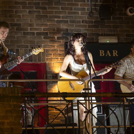 An image of a band performing on an exterior Live Event Stage for the Live At Your Local competition at The Anchor Bankside.