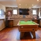 Interior of a pub with a pool table and a TV.