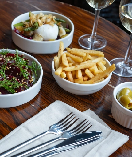 Selection of plates from the spring menu, plated and arranged on a wooden table