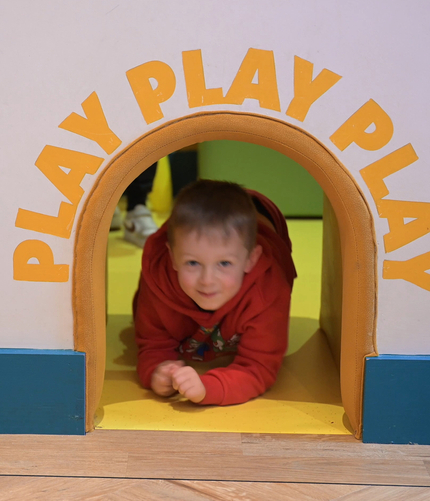 A child playing in the indoor play area at Hightales.