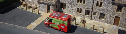 An external view of a building with a van parked in front