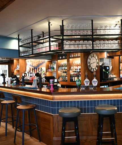 Interior bar area of a pub with a seating area.