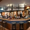 Interior bar area of a pub with a seating area.