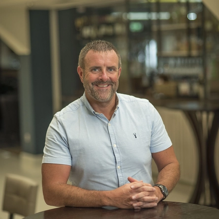 A portrait image of Mark Frankland smiling at the camera.