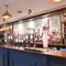 Interior seating area / restaurant with a TV on the wall
