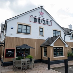 The exterior facade, signage and seating area at the Hem Heath.