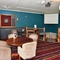 Interior dining area of a pub with a dartboard.